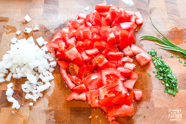 diced tomatoes and onion on cutting board