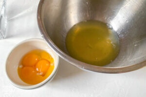 egg yolks and egg whites separated in two bowls