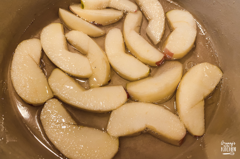 apple slices in pan with water