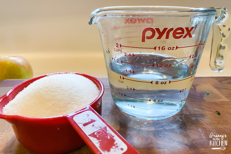 1 cup sugar and 1 cup water in measuring cups