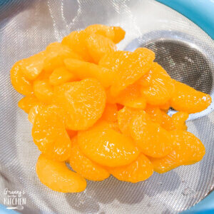draining canned mandarin oranges in strainer