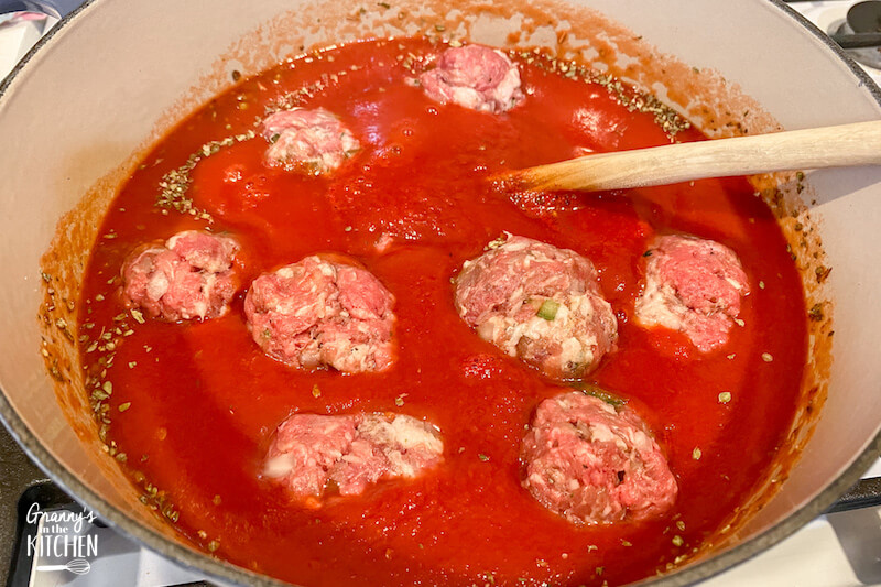 porcupine meatballs simmering in tomato sauce