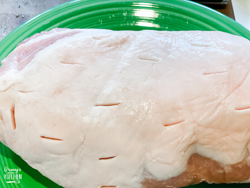 pork roast with slits in the top prior to cooking