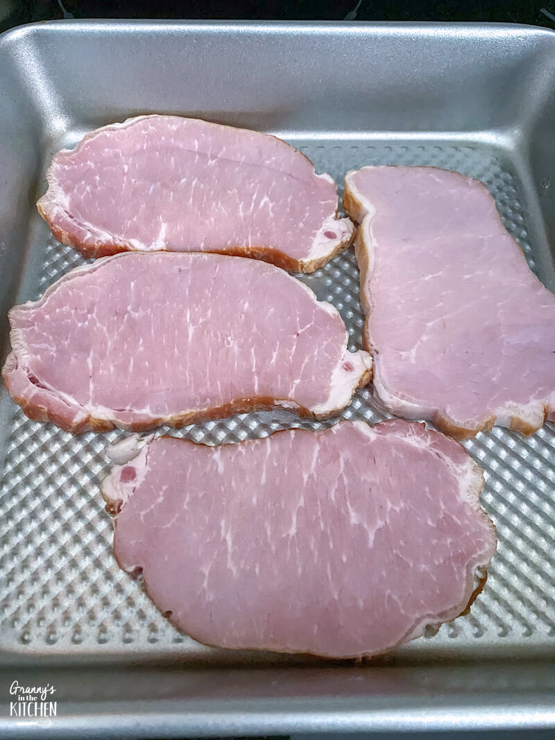 pork chops in bottom of a pan
