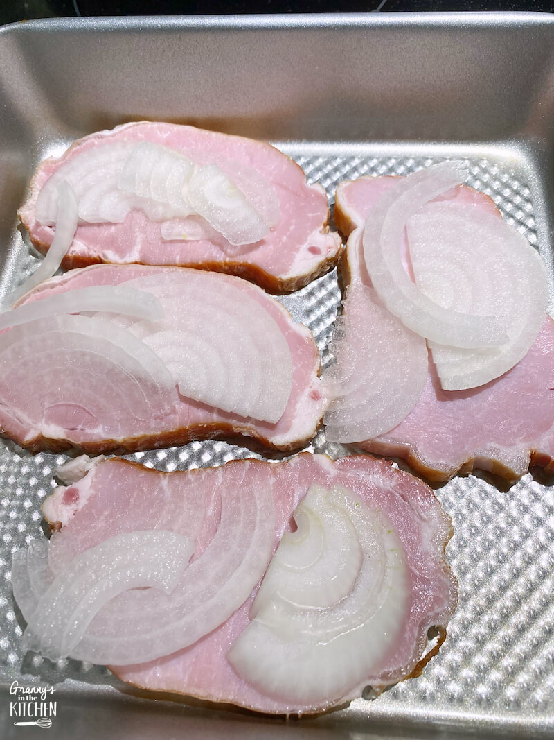 pork chops with sliced onions on top