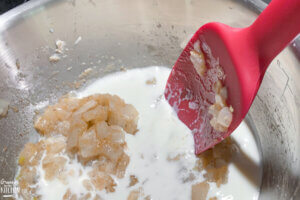 cooking a cream sauce with milk and diced onions
