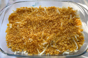 green bean casserole topped with corn flakes, ready to bake