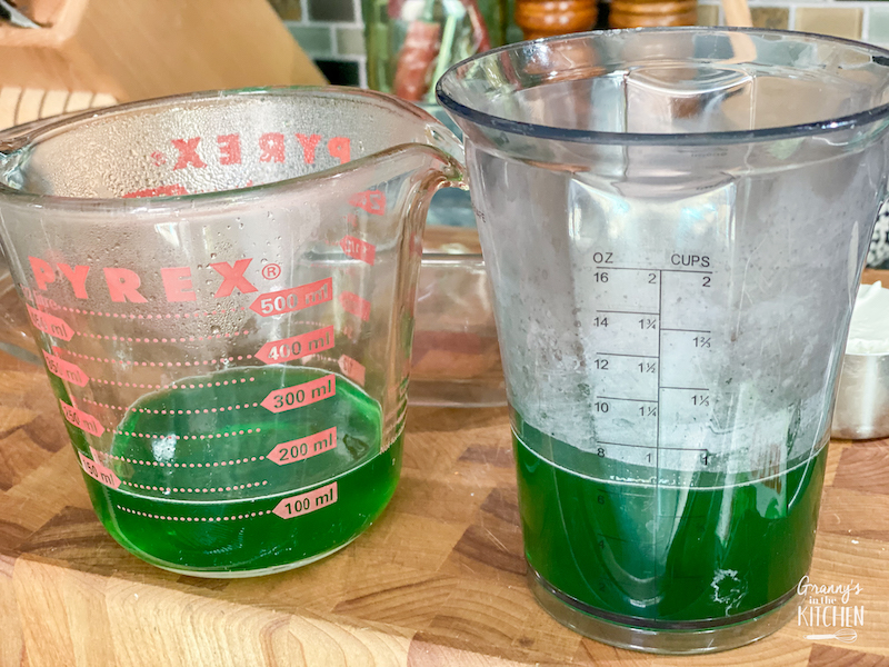 green jello liquid in measuring cups