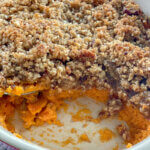 sweet potato casserole in baking dish with scoop missing