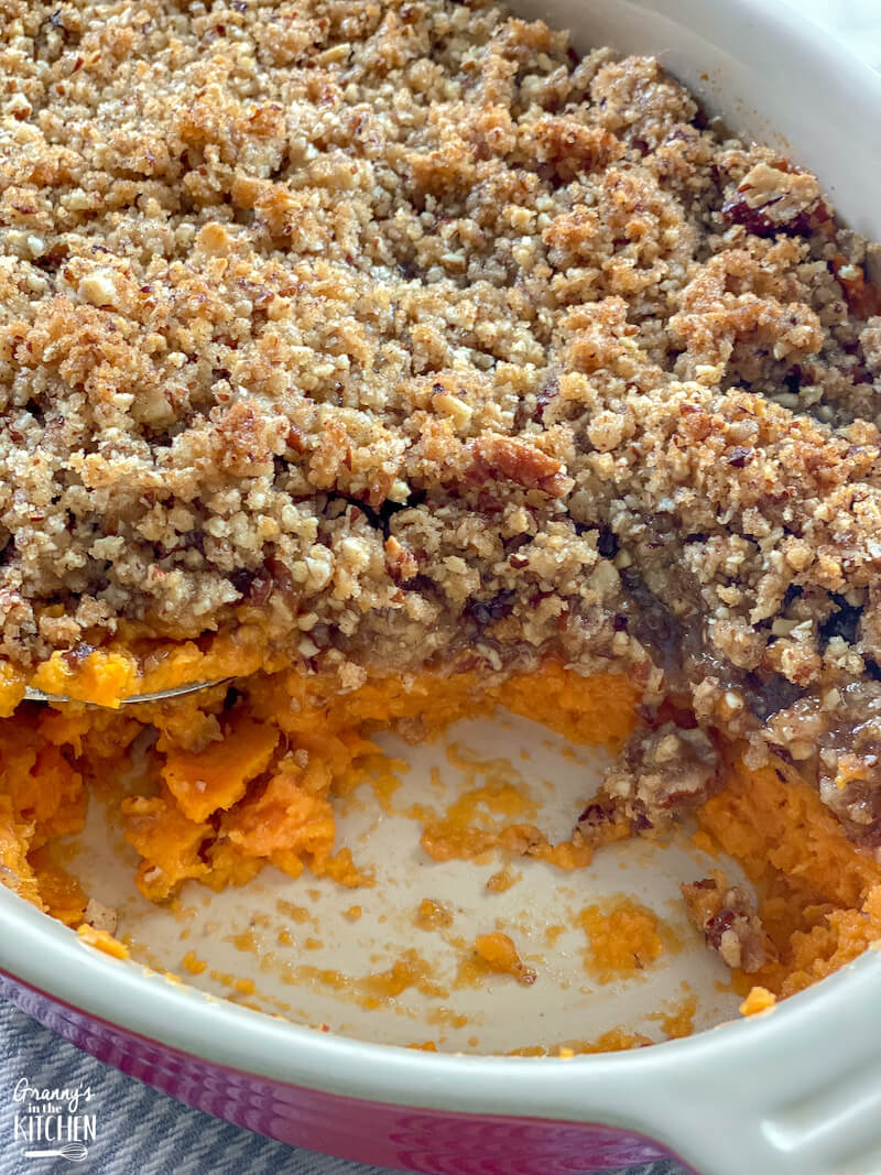 sweet potato casserole in baking dish with scoop missing