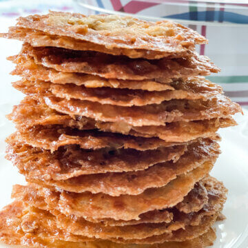 crispy oatmeal lace cookies stacked on plate