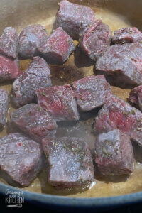 browning beef cubes in pan