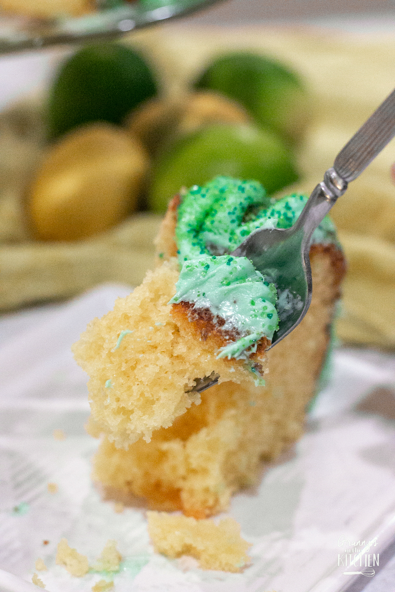 forkful of lemon cake with lime green icing