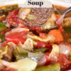 bowl of vegetable beef soup with beef cube on spoon