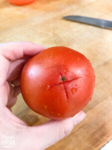 scoring bottom of tomato