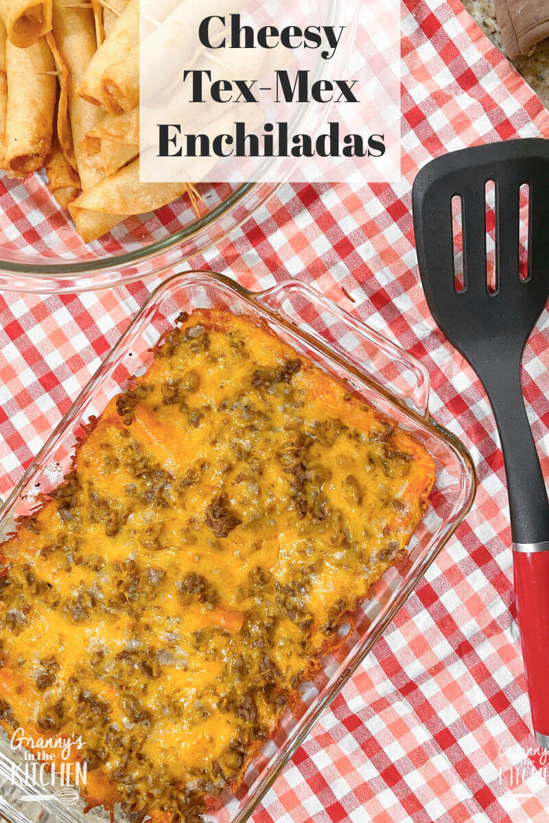 dish of red enchiladas on checked cloth
