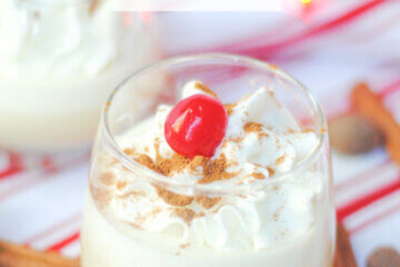 homemade eggnog with whipped cream and cherry