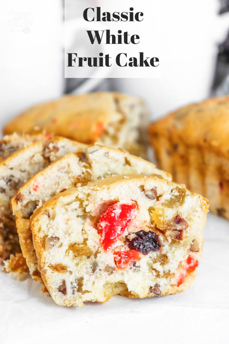white fruit cake filled with fruit and nuts
