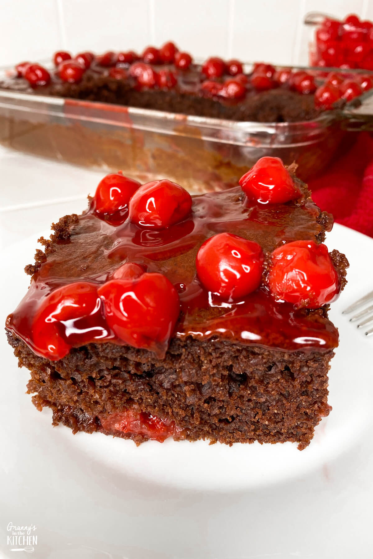 slice of chocolate cake with cherry pie filling on top