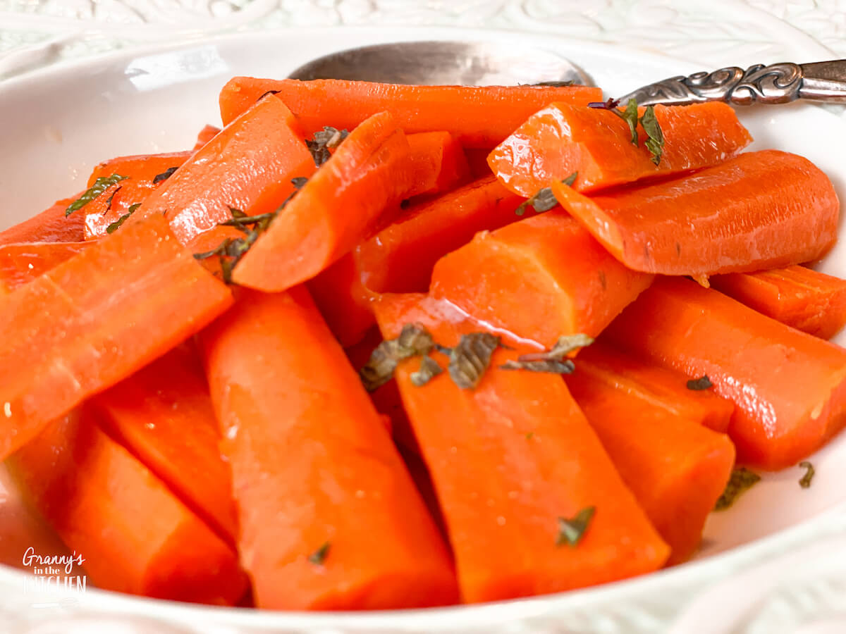 bowl of honey glazed carrots with fresh herbs