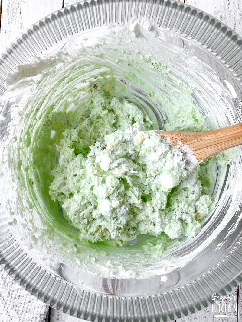 mixing up green fluff salad