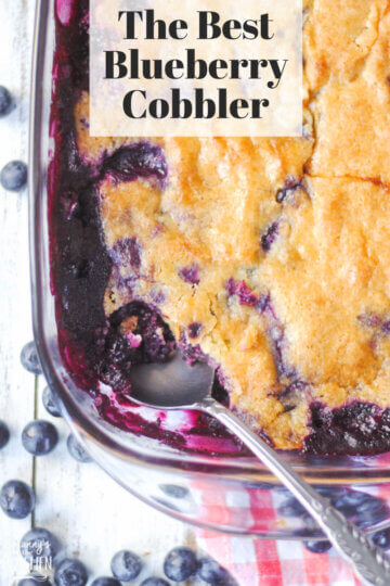 close up of a corner of a dish of homemade blueberry cobbler; text overlay "The Best Blueberry Cobbler"
