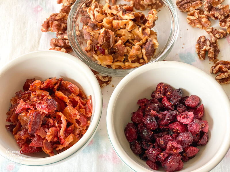 bowls of chopped bacon, cranberries, and walnuts