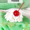 slice of green lime jello salad with cherry on top; text overlay "Vintage Lime Jello Salad"