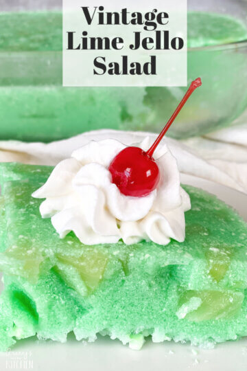 slice of green lime jello salad with cherry on top; text overlay "Vintage Lime Jello Salad"
