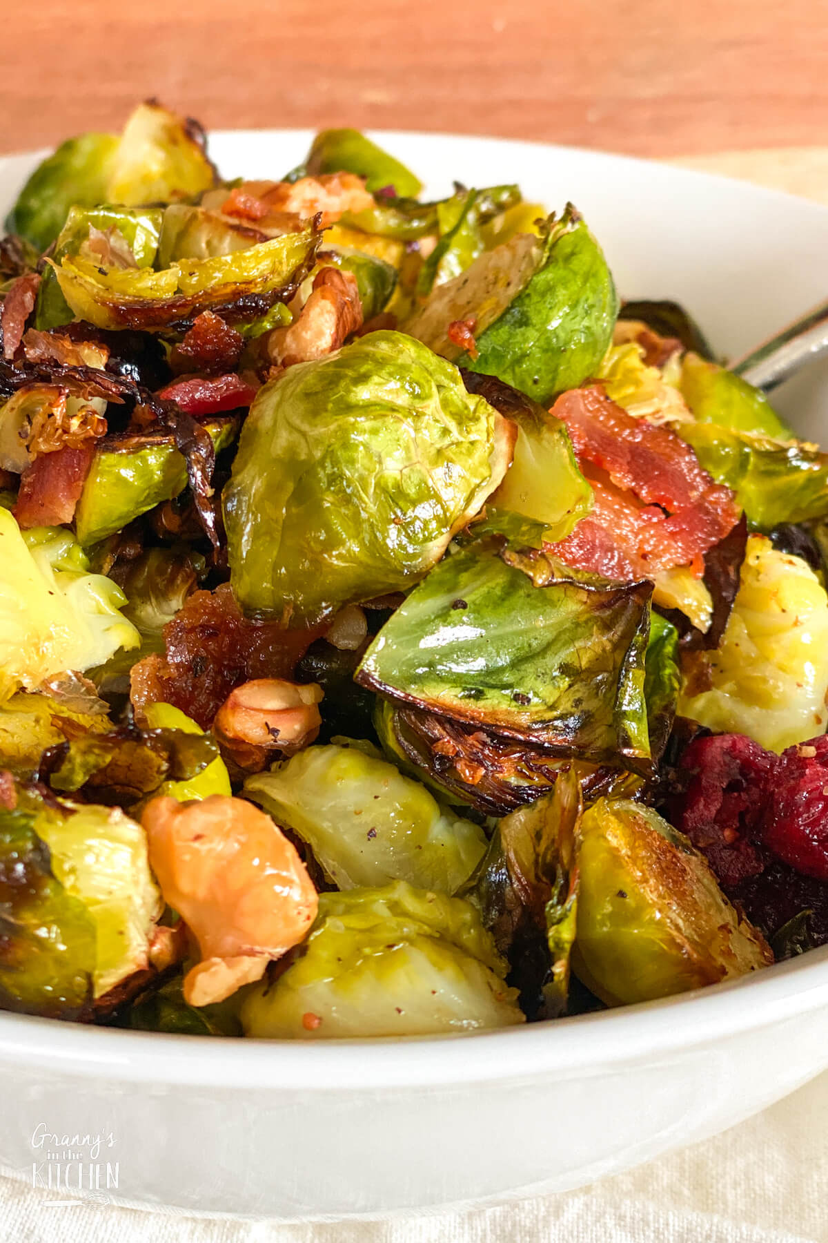 serving bowl with roasted Brussel sprouts, cranberries, bacon, and walnuts