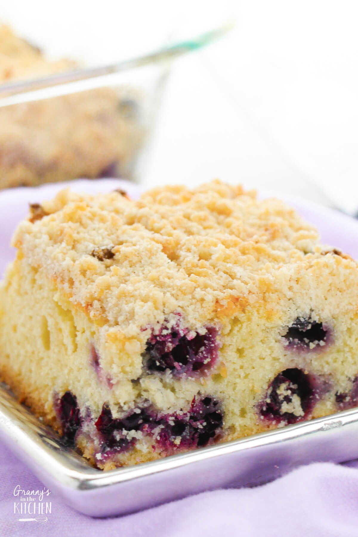 close up of a slice of blueberry buckle cake