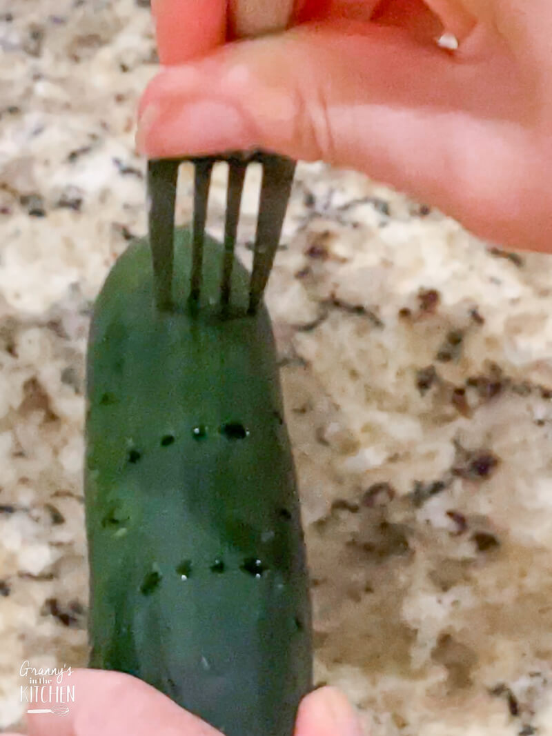 poking holes in a pickle with a fork