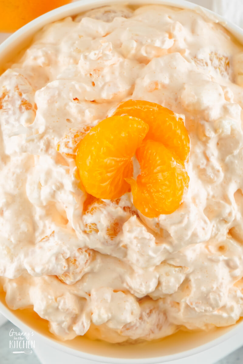 top-down view of a large serving bowl of orange fluff salad