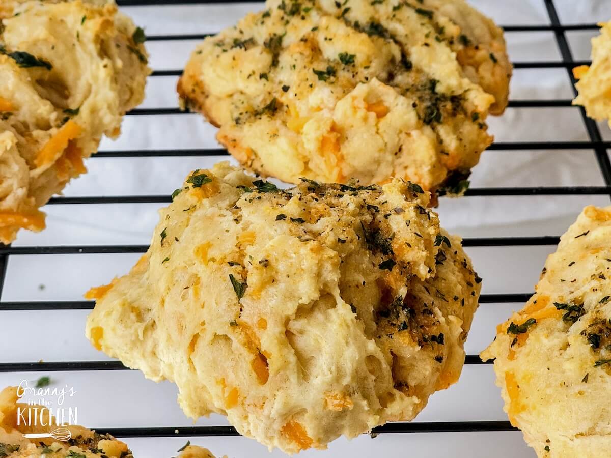 homemade Cheddar Bay biscuits on a wire baking rack.