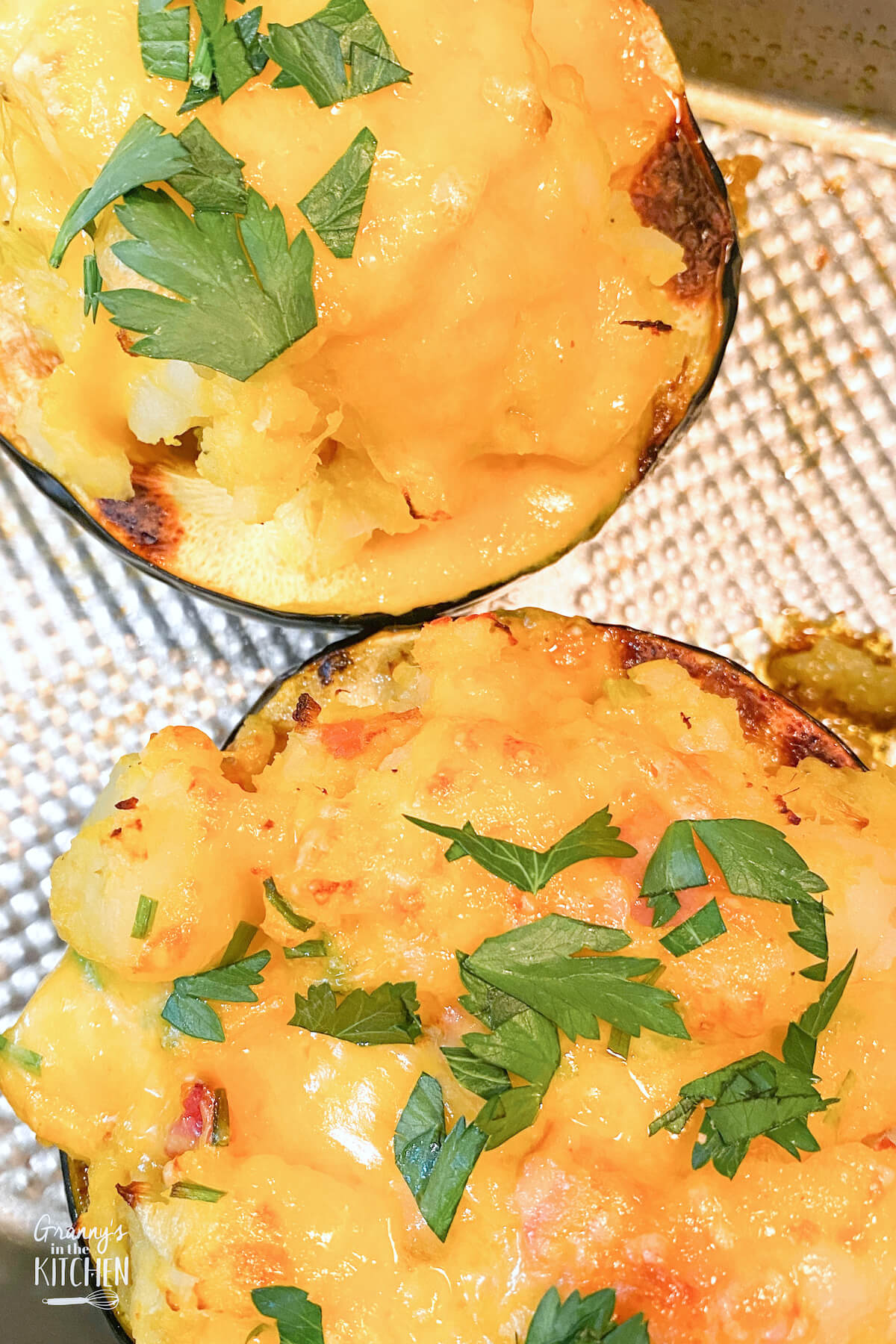 top down view of two acorn squash topped with cheese
