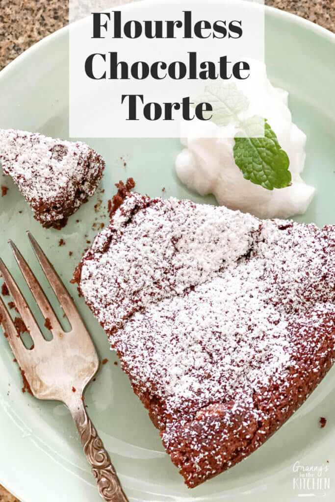 top-down view of a slice of chocolate cake; text overlay "Flourless Chocolate Torte"