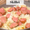skillet with sautéed cabbage and kielbasa; text overlay "Kielbasa Cabbage Skillet"