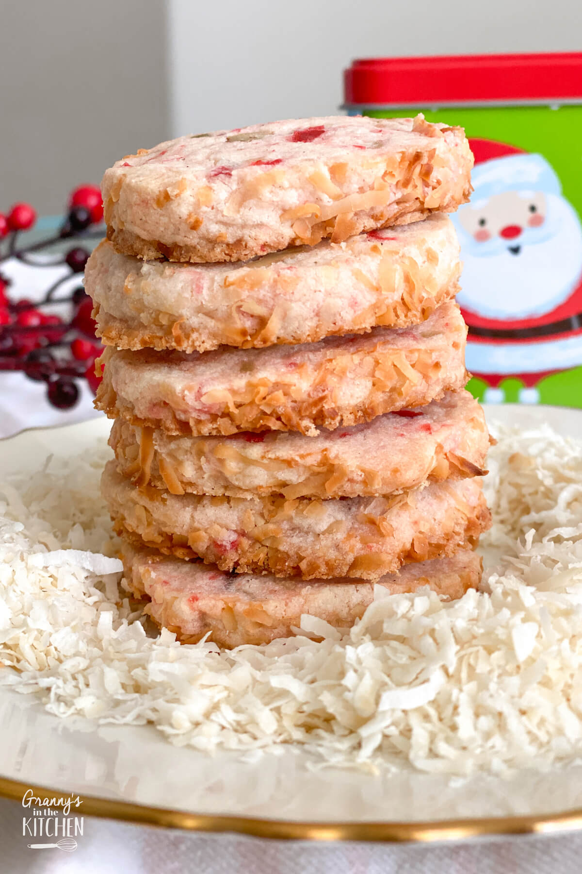 stack of holiday cookies on a plate with shredded coconut