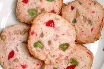 plate of holiday cookies with red and green cherries; text overlay "Santa's Whiskers"