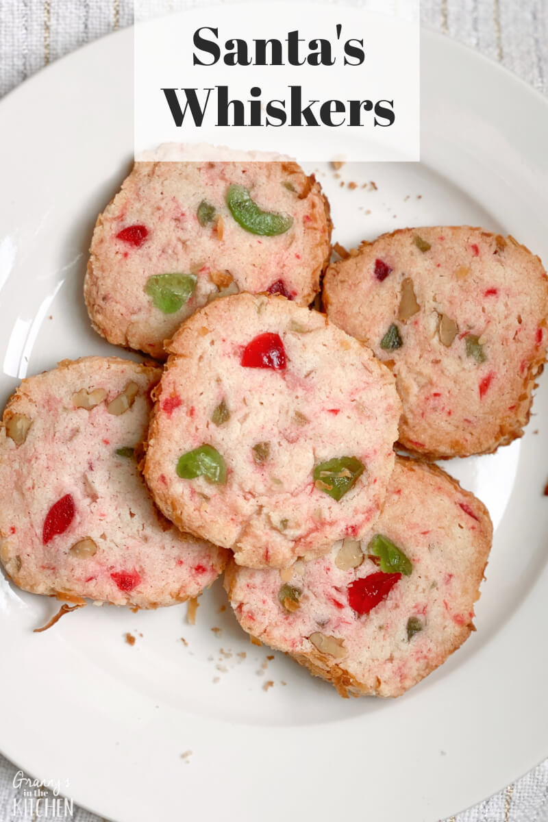 plate of holiday cookies with red and green cherries; text overlay "Santa's Whiskers"