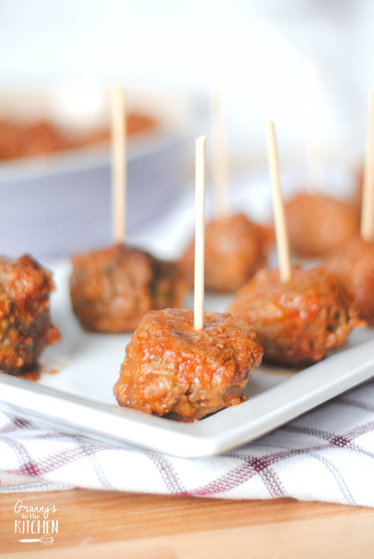 tray of cocktail meatballs with wooden toothpicks