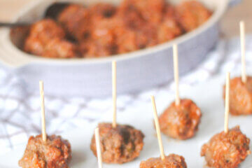 plate of cocktail meatballs; text overlay "Baked BBQ Meatballs"