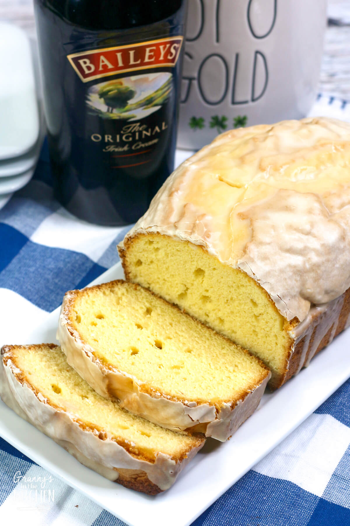 sliced pound cake with a bottle of bailey's behind it