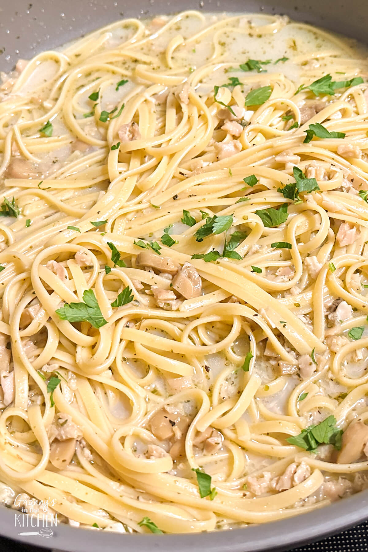 saute pan of cooked linguine with white clam sauce
