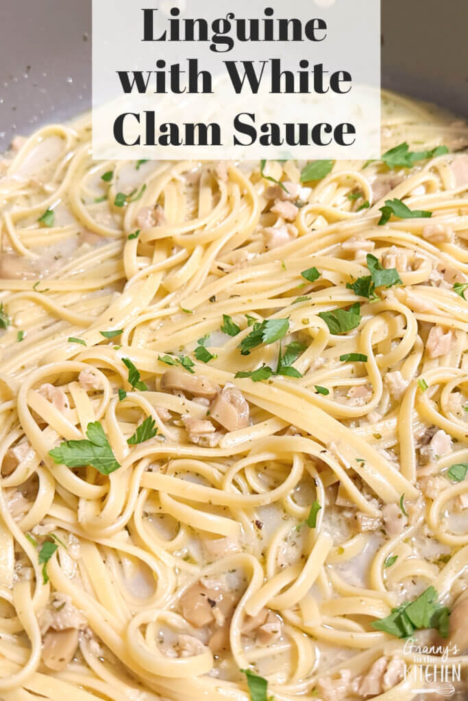pan of cooked pasta with parsley; text overlay "Linguine with White Clam Sauce"