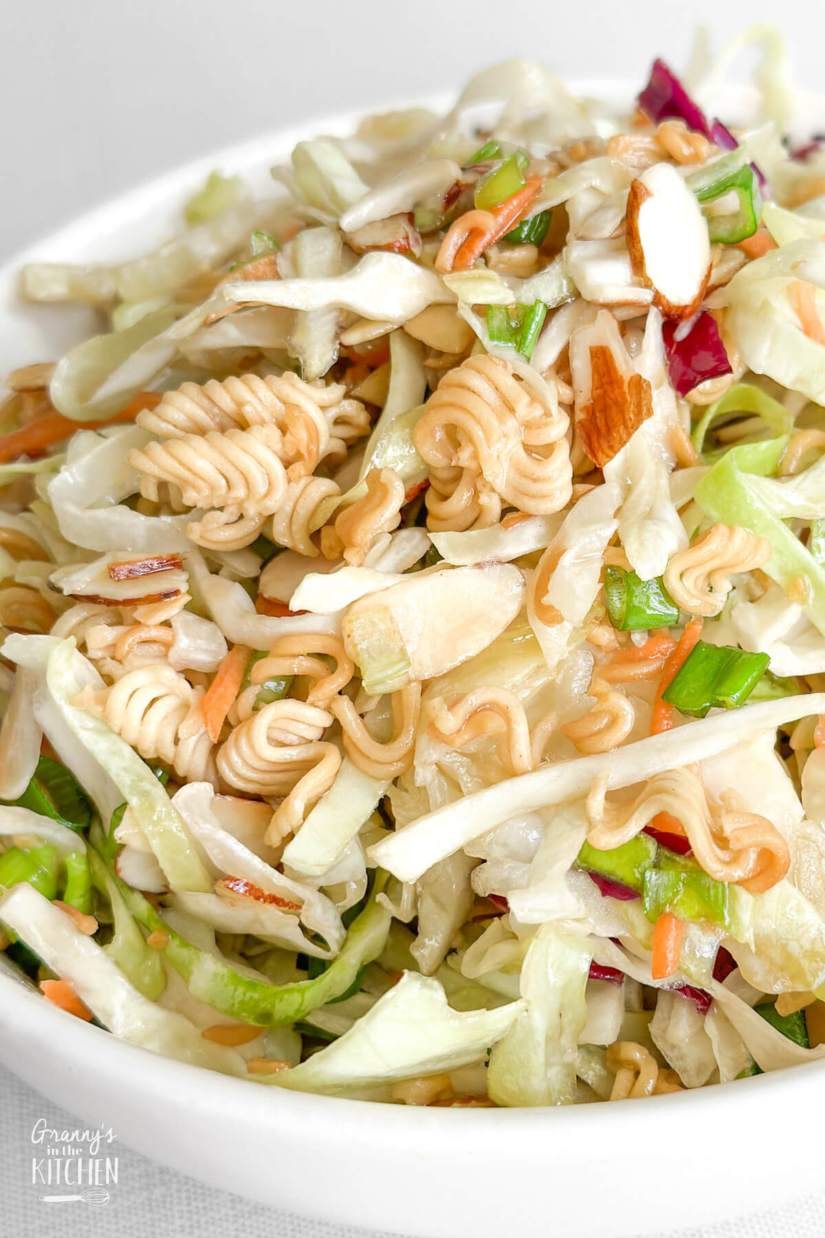 detail shot of Asian cabbage slaw in a white bowl
