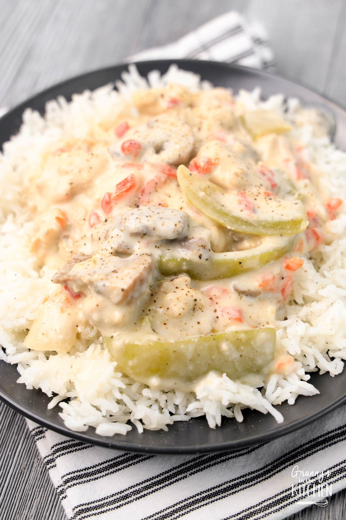 plated Chicken a la King dish with creamy sauce and vegetables over rice