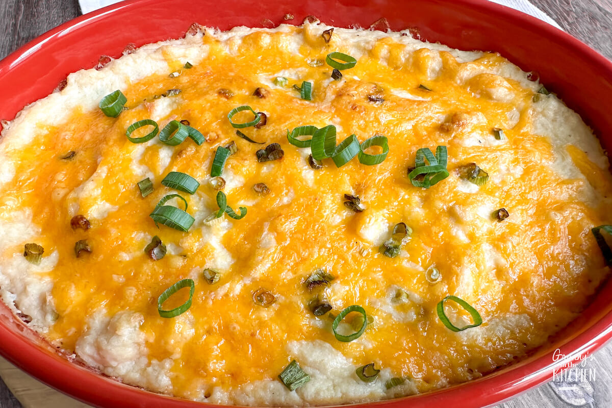cheesy celery root casserole in red baking dish