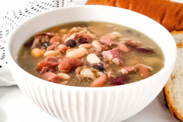 bowl of ham bean soup, with text overlay "Stovetop Ham & Bean Soup"