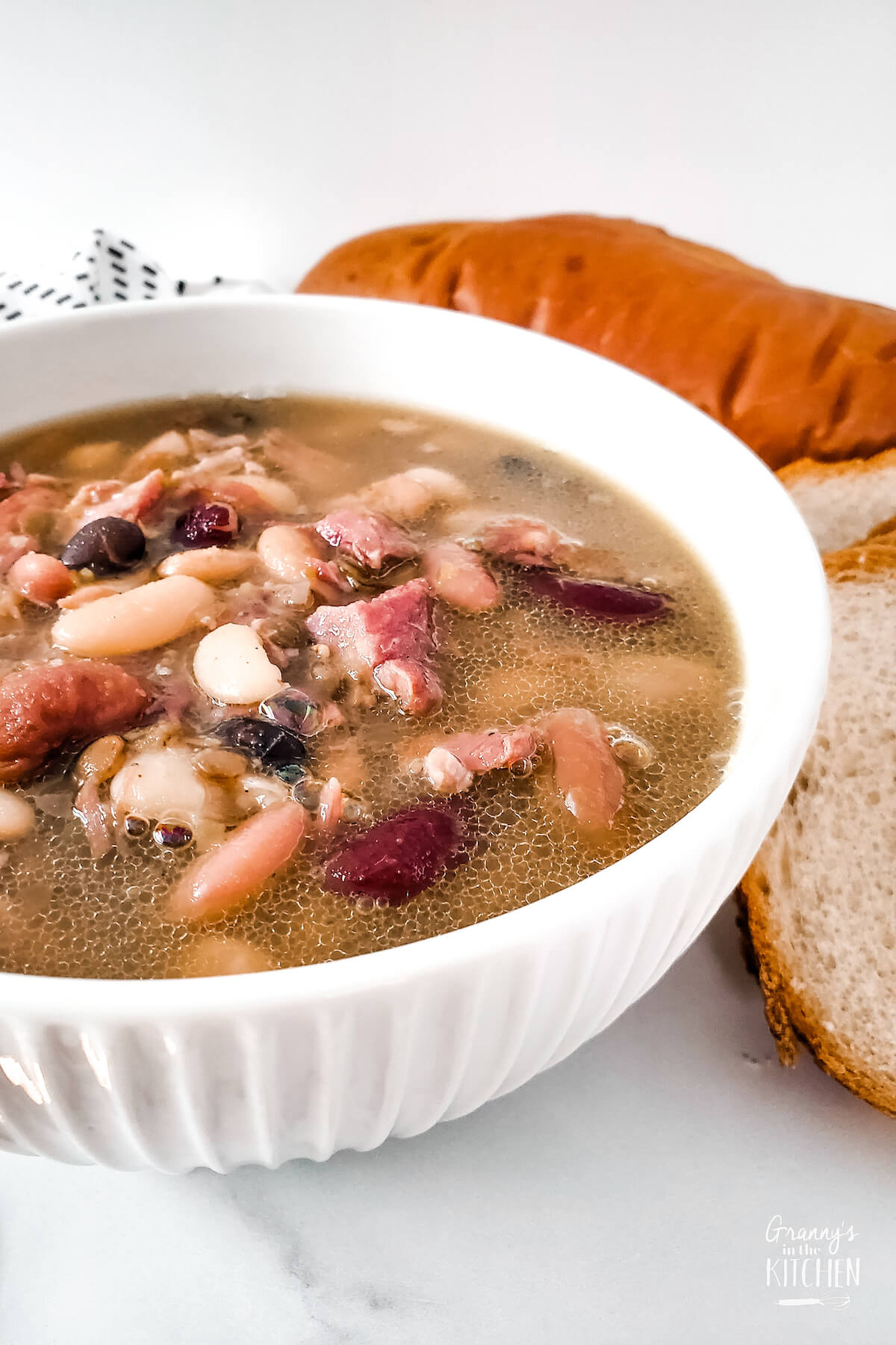 bowl of ham bean soup and slices of bread
